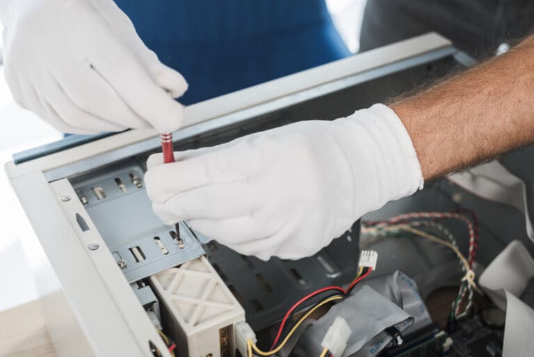 Close up male technician hand wearing glove repairing a machine, working on an air conditioning system