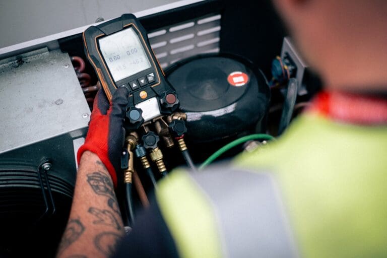 Engineer completing air conditioning and heat pumps maintenance on the Isle of Wight